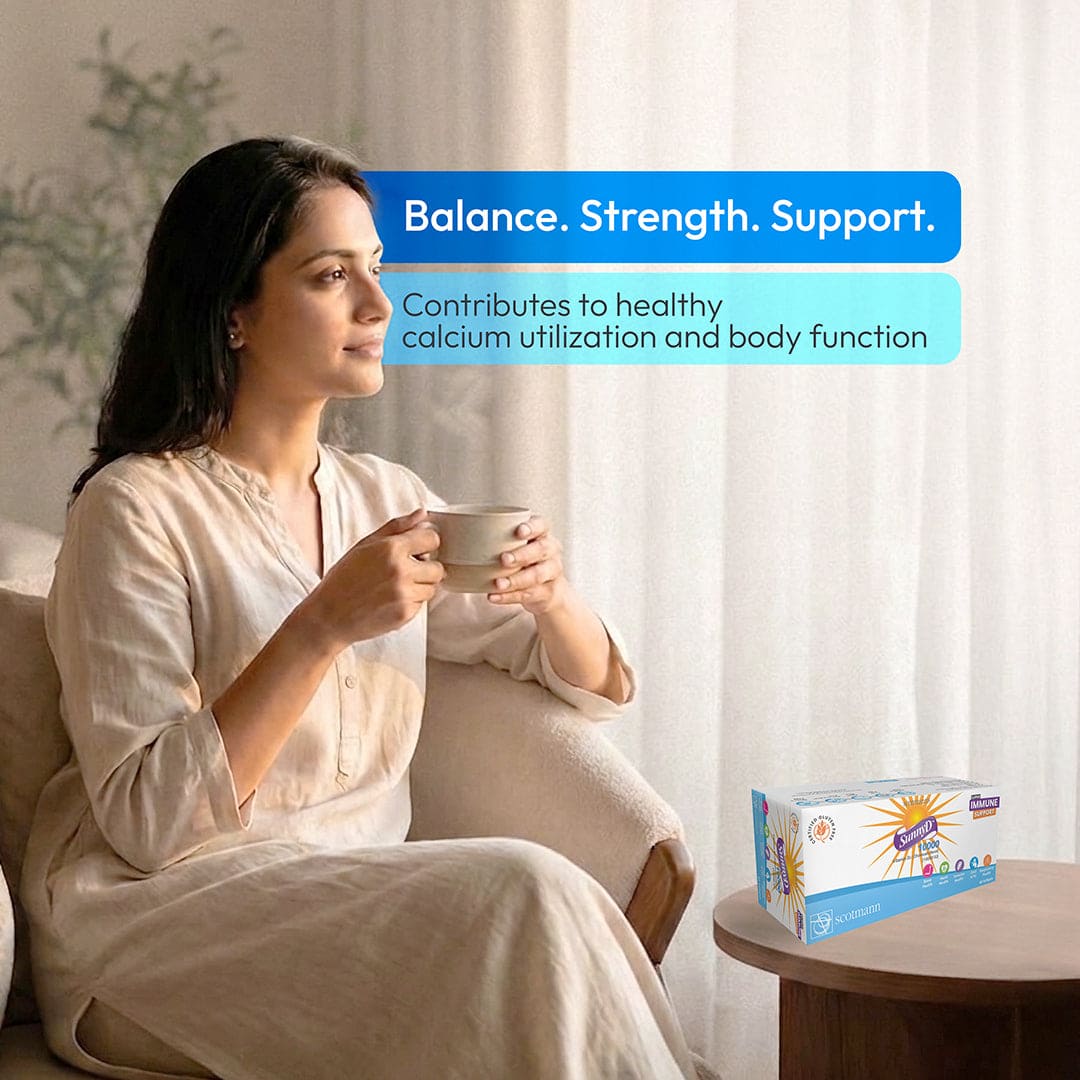 Woman holding a mug with a product box labeled 'Balance. Strength. Support.' in the background.