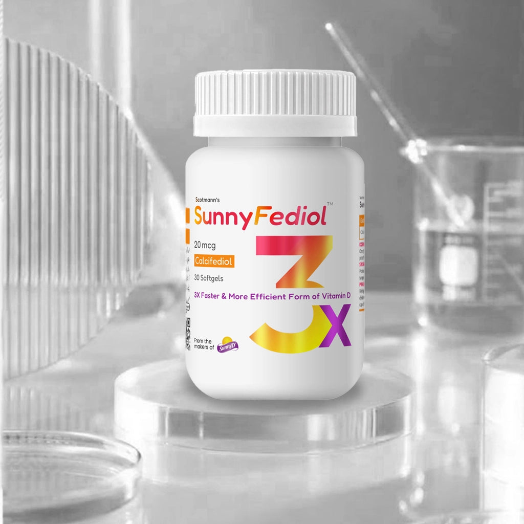 A white bottle of SunnyFediol ZX Vitamin G120 softgels, positioned on a clear acrylic pedestal. The background is a soft-focus, monochrome laboratory setting with glass beakers and a pipette.