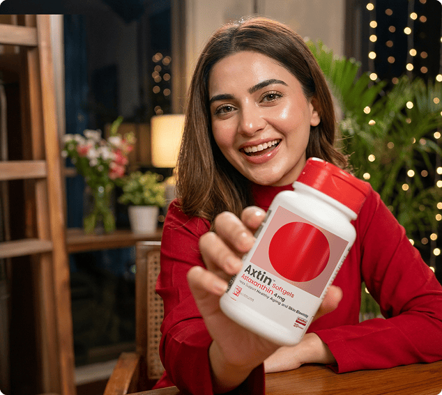 Woman holding a supplement container with a blurred indoor background